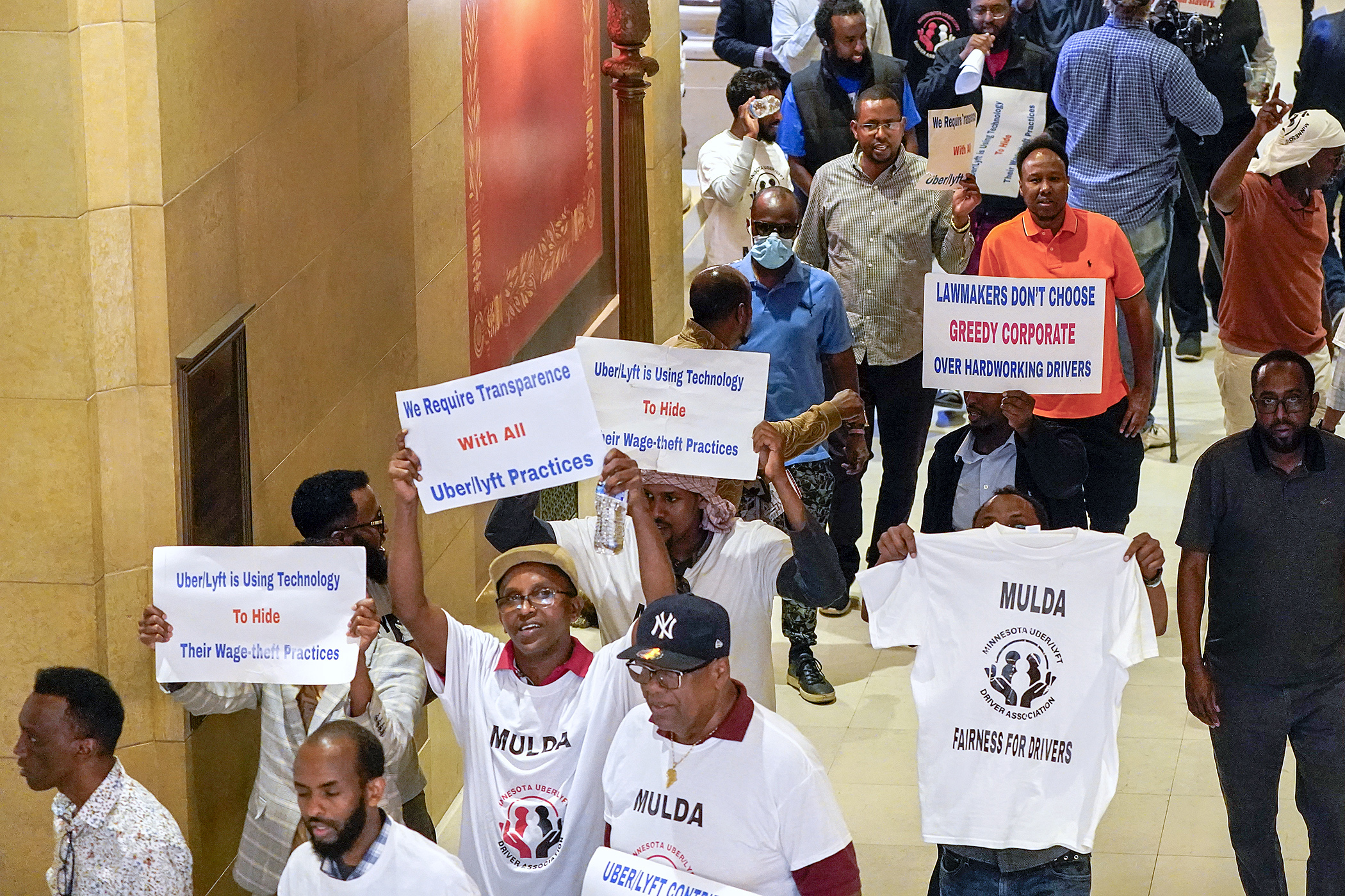 Rideshare drivers and their supporters rally outside of the House Chamber May 17. Lawmakers have sought a compromise on legislation to regulate transportation network companies like Uber and Lyft in the waning days of the 2024 legislative session. (Photo by Michele Jokinen)
